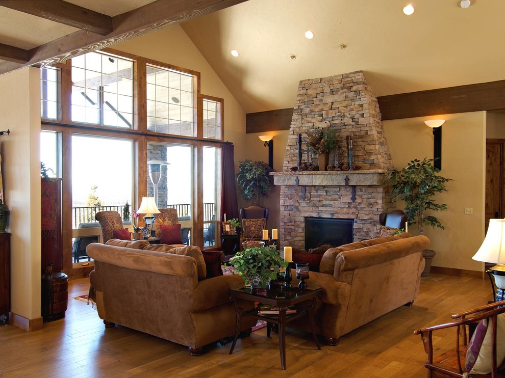 Design ideas for a mid-sized traditional living room in Portland with beige walls, light hardwood floors, a standard fireplace and a stone fireplace surround.