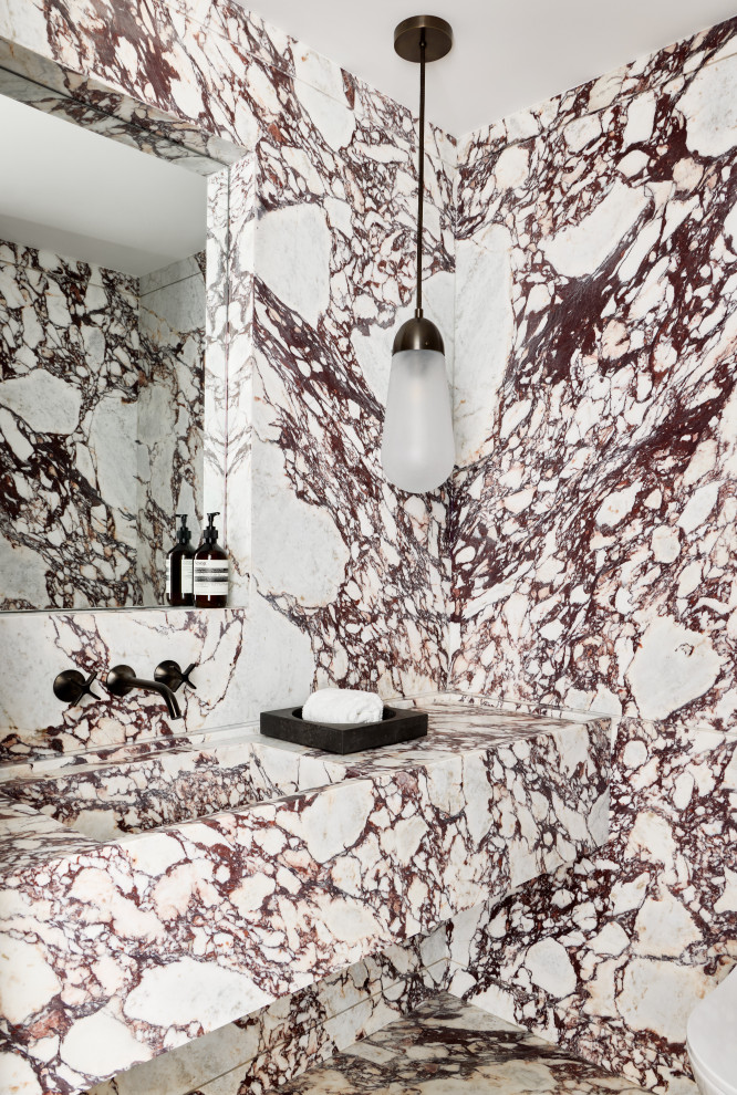 Mid-sized trendy multicolored tile and marble tile marble floor, multicolored floor and single-sink bathroom photo in New York with red cabinets, a wall-mount toilet, an integrated sink, marble countertops, multicolored countertops and a floating vanity