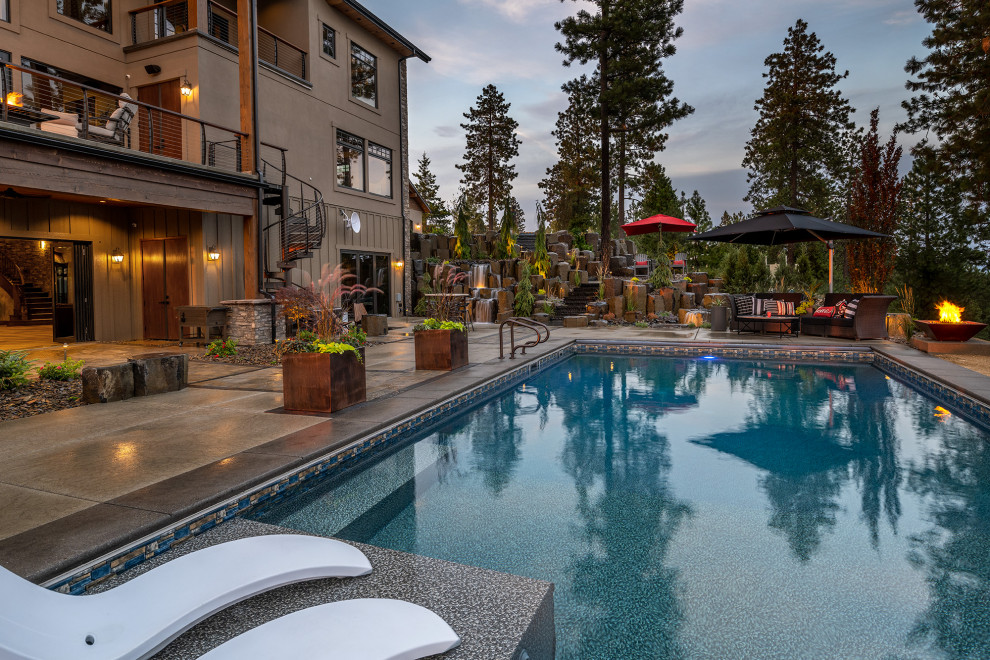 Photo of a large arts and crafts backyard rectangular lap pool in Seattle with with a pool and natural stone pavers.