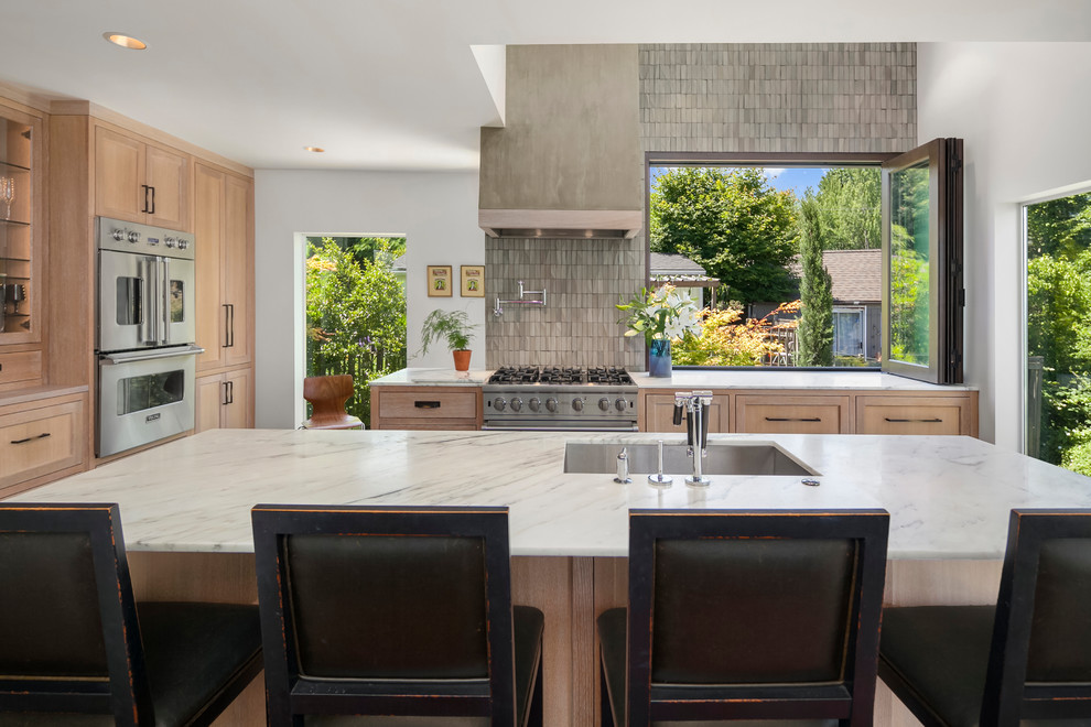 Large trendy l-shaped dark wood floor and brown floor open concept kitchen photo in Seattle with an undermount sink, recessed-panel cabinets, light wood cabinets, marble countertops, gray backsplash, cement tile backsplash, stainless steel appliances and an island