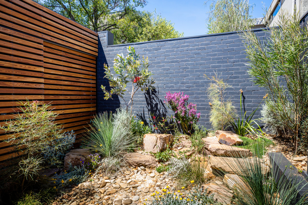 Design ideas for a small and australian native courtyard partial sun garden for spring in Melbourne with with rock feature and river rock.