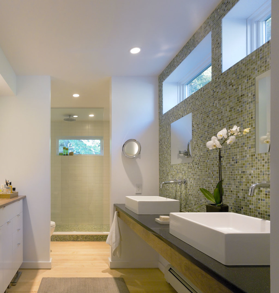 This is an example of a modern bathroom in Burlington with a vessel sink, flat-panel cabinets, white cabinets, an alcove shower, mosaic tile, white walls and light hardwood floors.