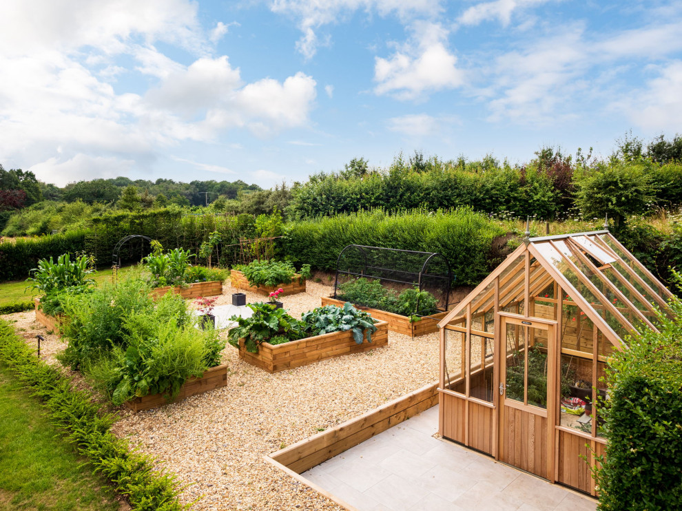 Ejemplo de jardín de estilo de casa de campo grande en patio trasero con jardín de macetas, exposición total al sol y gravilla