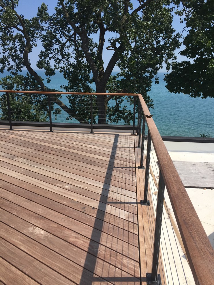 This is an example of a large transitional backyard deck in Chicago with no cover.