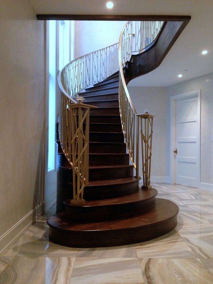 Mid-sized transitional wood curved staircase in New York with wood risers.