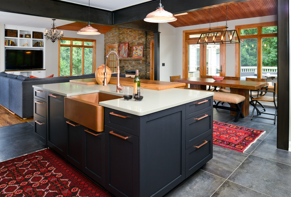 Photo of a mid-sized eclectic l-shaped open plan kitchen in DC Metro with a farmhouse sink, shaker cabinets, white cabinets, quartz benchtops, multi-coloured splashback, stone tile splashback, stainless steel appliances, porcelain floors, with island and grey floor.