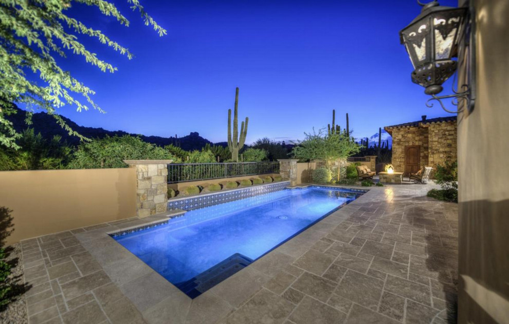 Photo of an expansive transitional backyard rectangular natural pool in Phoenix with natural stone pavers.