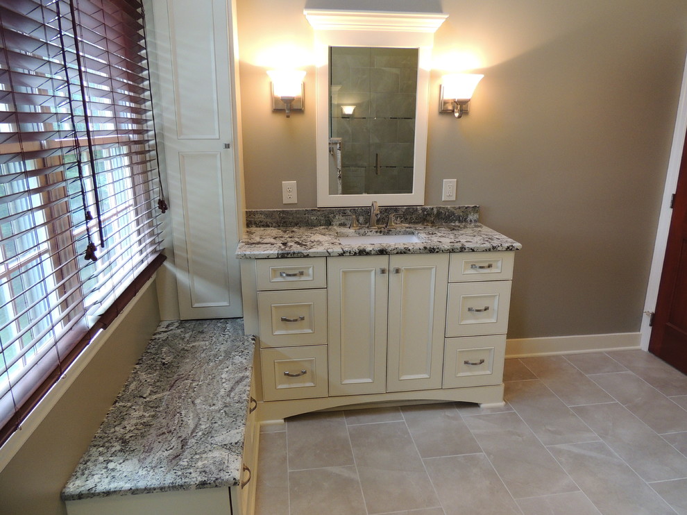 Large transitional master bathroom in Other with an undermount sink, recessed-panel cabinets, white cabinets, granite benchtops, a corner shower, a one-piece toilet, gray tile, porcelain tile, grey walls and porcelain floors.