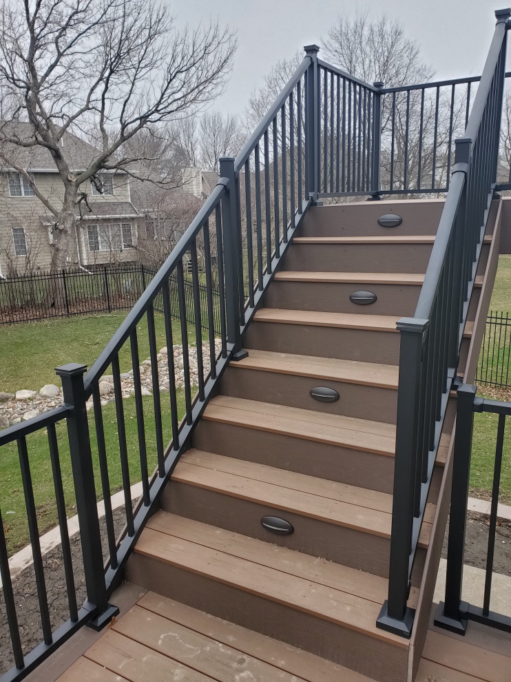 Inspiration for a large backyard second story metal railing deck remodel with no cover