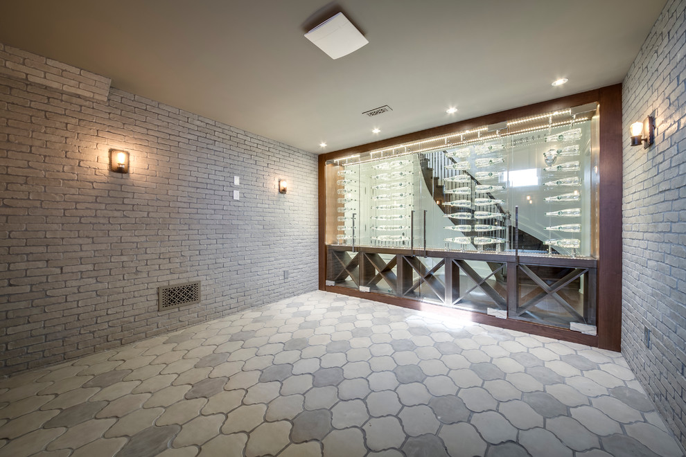 This is an example of a mid-sized modern wine cellar in Toronto with concrete floors and diamond bins.