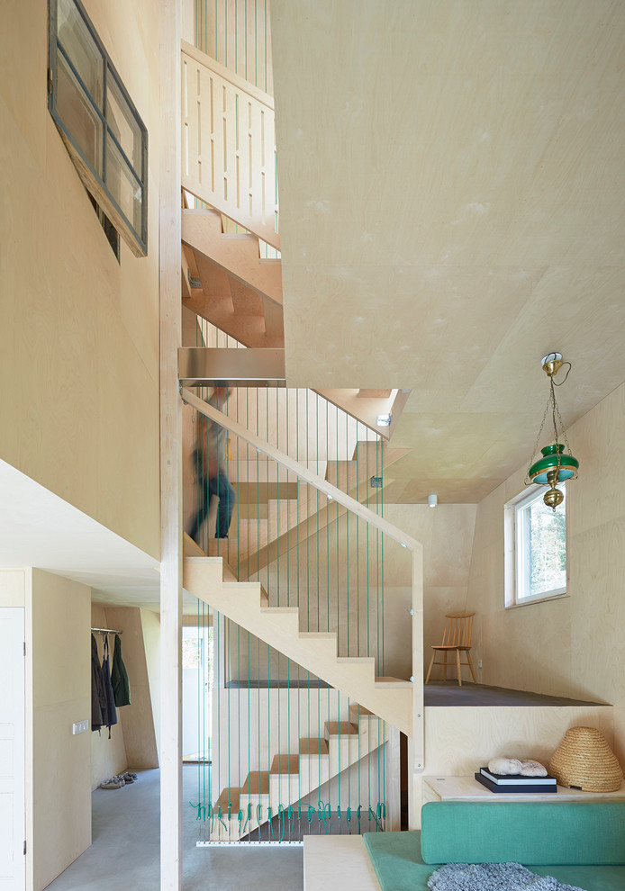 This is an example of a large scandinavian wood u-shaped staircase in Stockholm with wood risers.