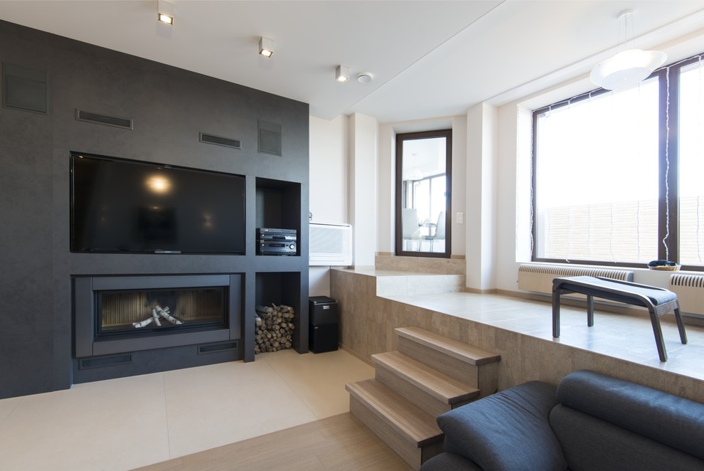 Photo of a contemporary living room in Berlin with white walls, a ribbon fireplace and a built-in media wall.