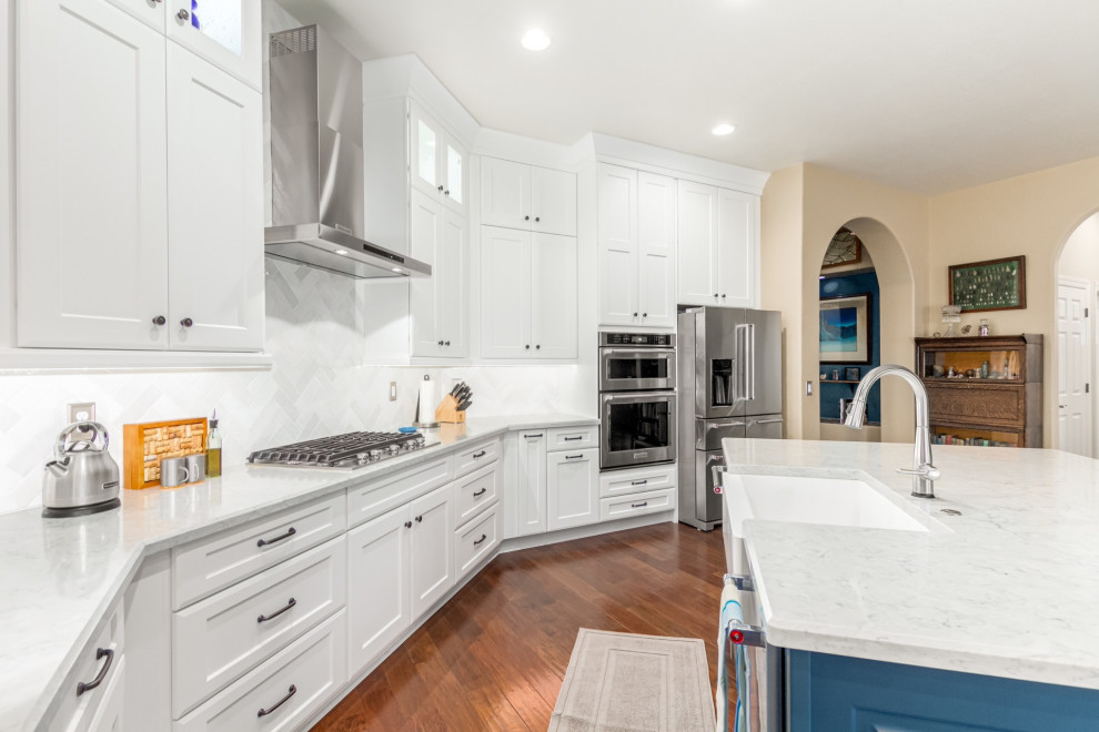 Transitional kitchen photo in Phoenix with a farmhouse sink, shaker cabinets, white cabinets, white backsplash, subway tile backsplash and white countertops