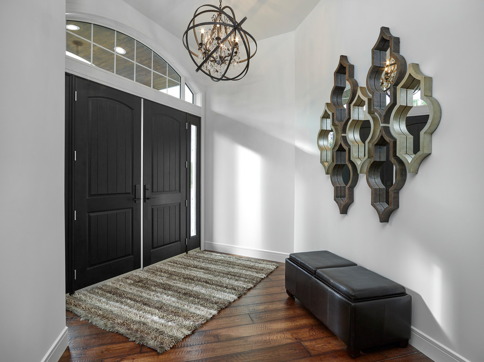 Inspiration for a mid-sized craftsman medium tone wood floor and brown floor double front door remodel with gray walls and a dark wood front door