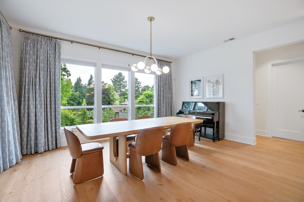 Kitchen/dining room combo - large mid-century modern light wood floor and beige floor kitchen/dining room combo idea in Portland with white walls