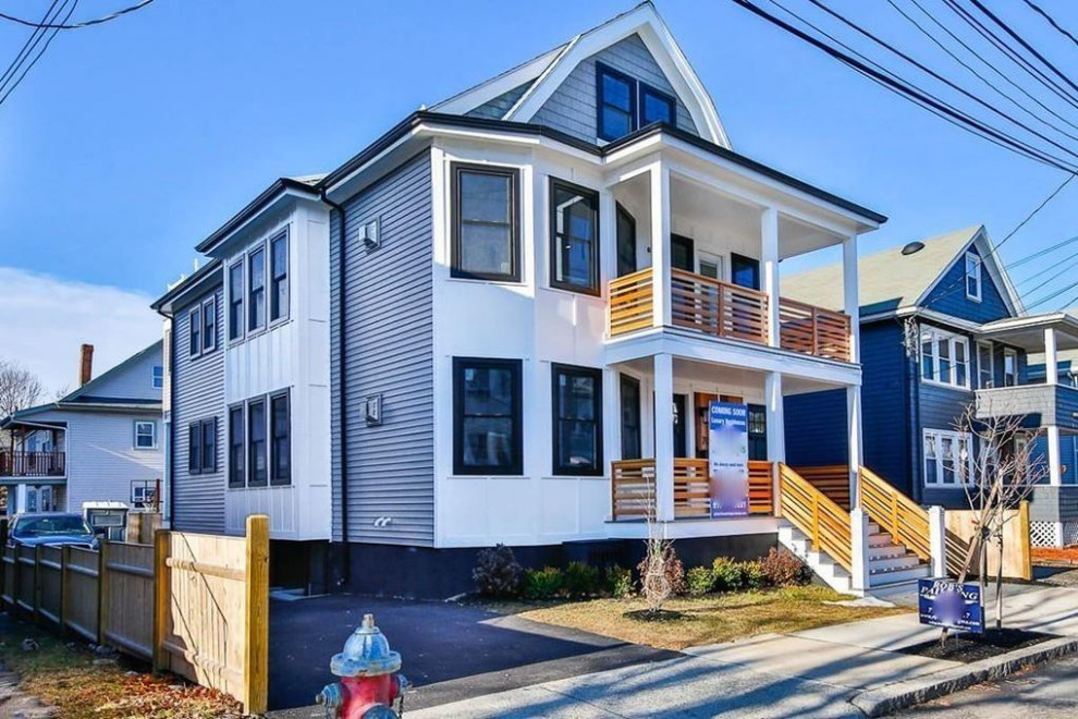 Mid-sized modern three-storey blue duplex exterior in Boston with mixed siding, a gable roof and a shingle roof.