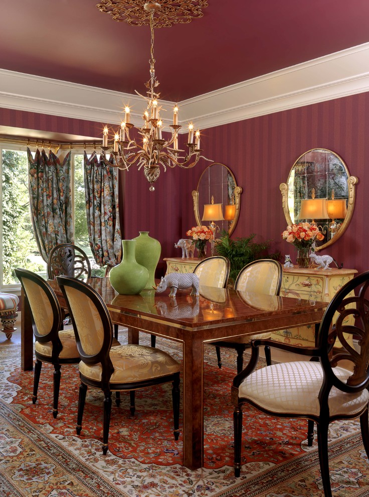 Inspiration for a traditional separate dining room in St Louis with red walls.