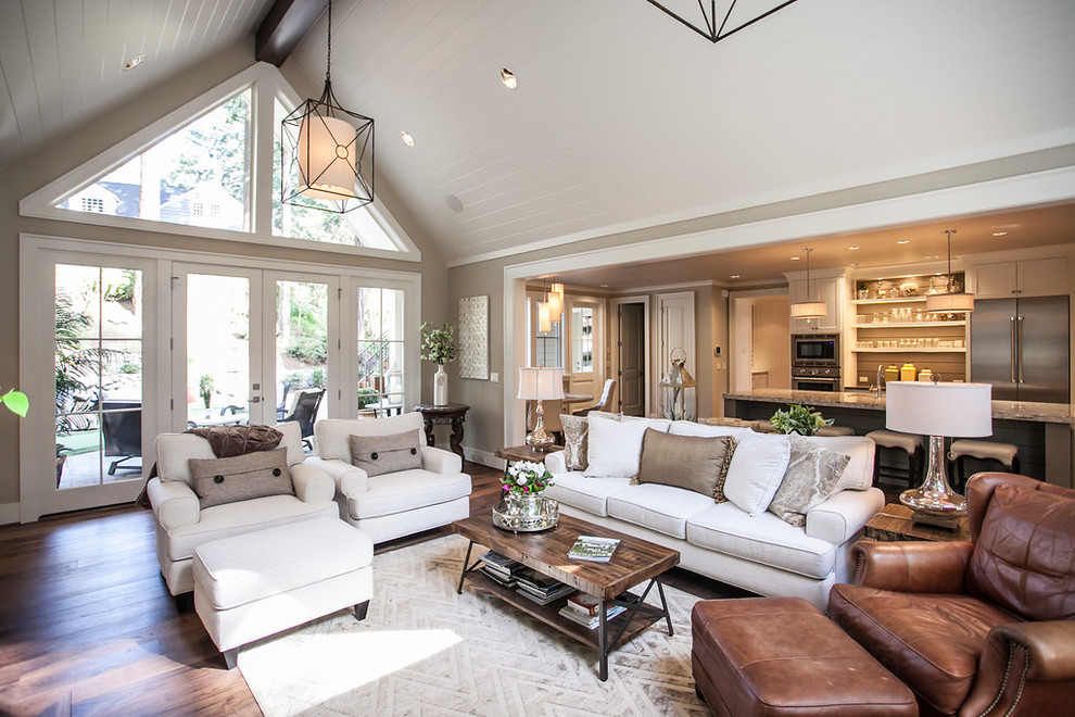 Design ideas for a mid-sized transitional open concept living room in Portland with grey walls, dark hardwood floors, a standard fireplace, a stone fireplace surround, a built-in media wall and brown floor.