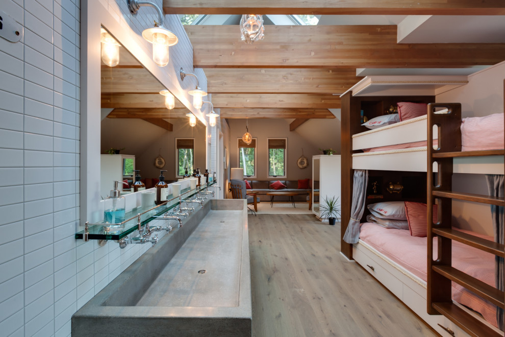 This is an example of an expansive modern guest bedroom in Milwaukee with white walls, light hardwood floors and brown floor.