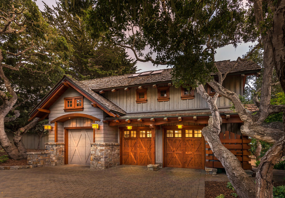 Example of an arts and crafts three-car garage design in Sacramento