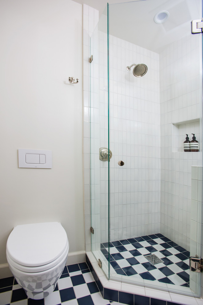 Design ideas for a small contemporary 3/4 bathroom in Los Angeles with white cabinets, a corner shower, a one-piece toilet, white tile, white walls, ceramic floors, a pedestal sink, multi-coloured floor, a hinged shower door, a single vanity and a freestanding vanity.