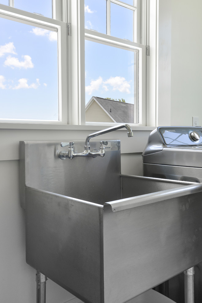 Inspiration for a traditional laundry room in Charleston with an utility sink.