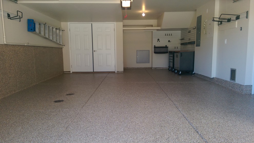 Inspiration for a mid-sized transitional attached two-car garage workshop remodel in Denver