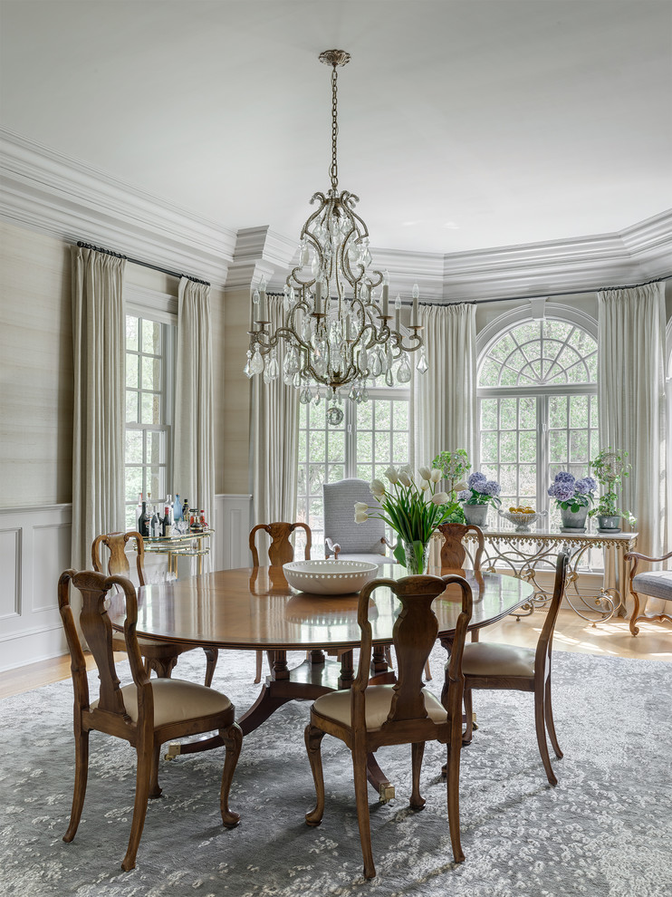 Inspiration for a large traditional dining room in New York with grey walls, medium hardwood floors and brown floor.
