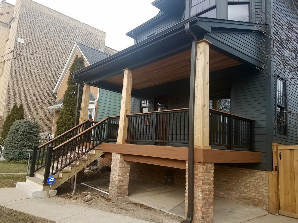 Photo of a mid-sized traditional three-storey grey house exterior in Chicago with concrete fiberboard siding.