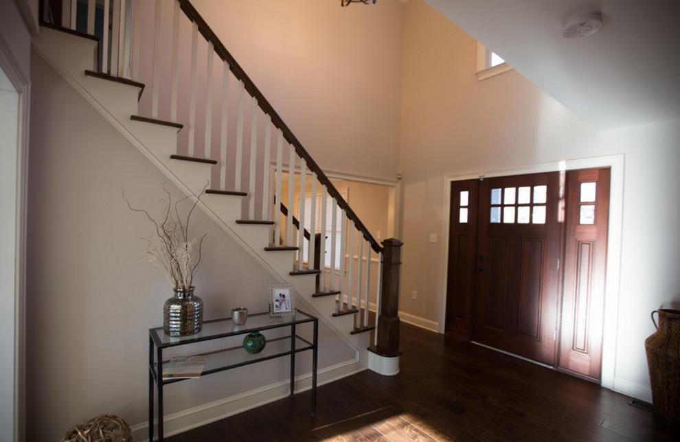 Inspiration for a mid-sized transitional dark wood floor and brown floor foyer remodel in Philadelphia with beige walls and a dark wood front door