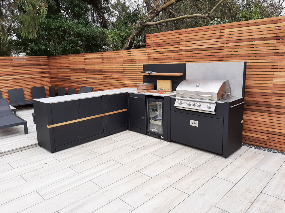 Small modern backyard patio in Berkshire with an outdoor kitchen, decking and no cover.