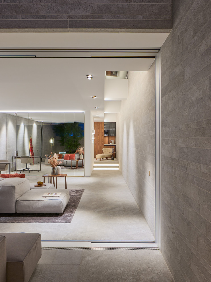 Diseño de salón para visitas minimalista con televisor retractable y piedra