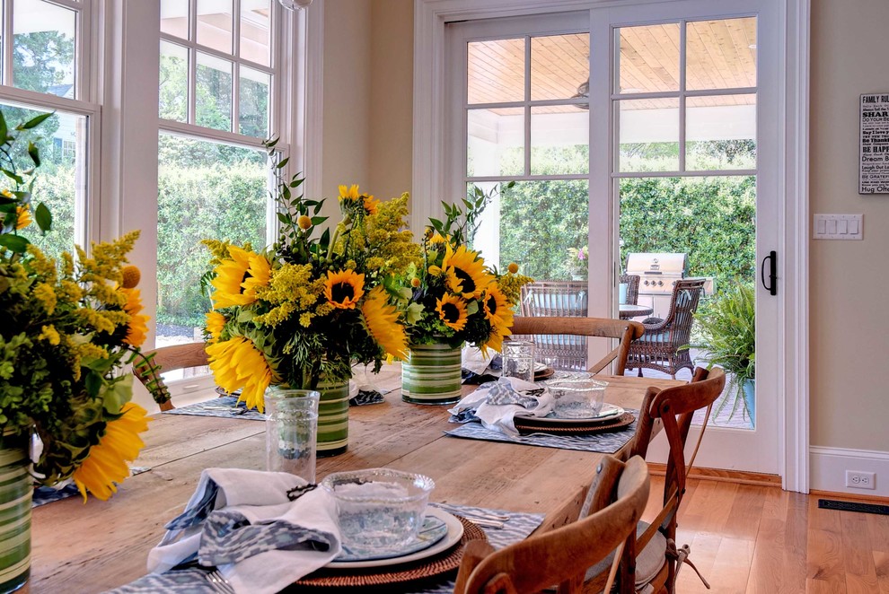 Inspiration for a transitional medium tone wood floor eat-in kitchen remodel with an undermount sink, shaker cabinets, white cabinets, marble countertops, gray backsplash, subway tile backsplash, stainless steel appliances and an island