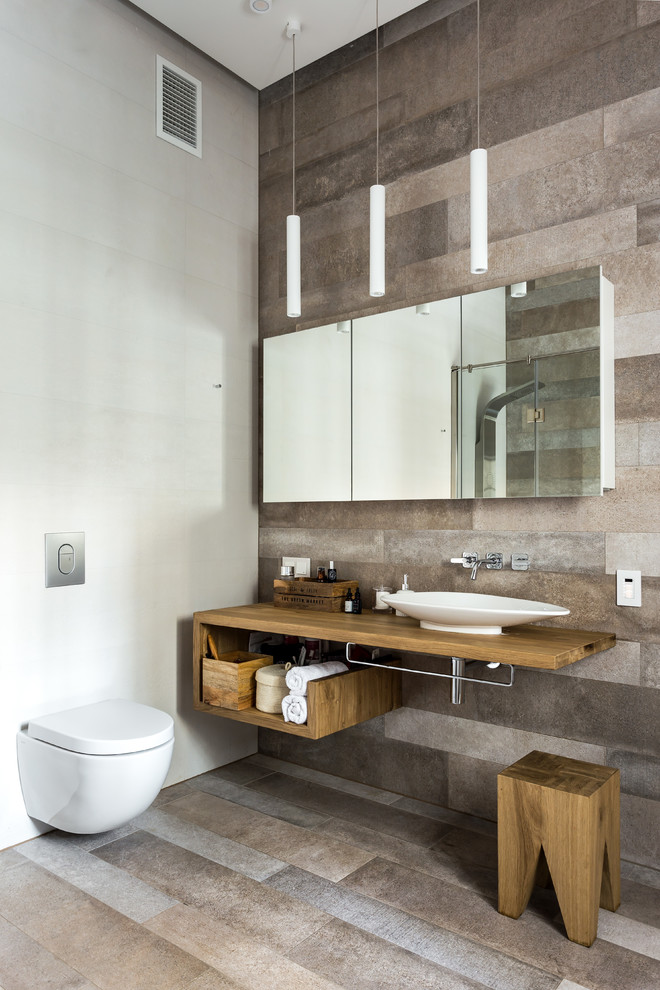 Inspiration for a mid-sized contemporary 3/4 bathroom in Moscow with open cabinets, brown cabinets, a freestanding tub, a curbless shower, a two-piece toilet, beige tile, ceramic tile, beige walls, porcelain floors, a drop-in sink, wood benchtops, grey floor, a hinged shower door and brown benchtops.