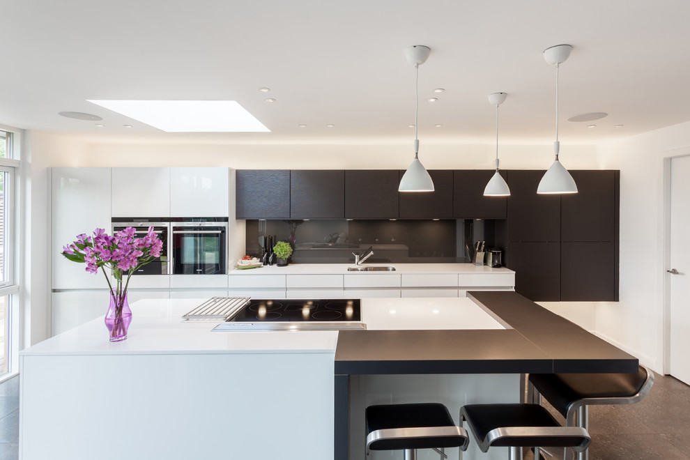 Contemporary kitchen in Glasgow with a single-bowl sink, flat-panel cabinets, brown cabinets, brown splashback, glass sheet splashback, with island and white benchtop.