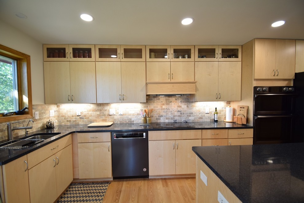 Kitchen - transitional light wood floor and beige floor kitchen idea with a double-bowl sink, flat-panel cabinets, light wood cabinets, quartz countertops, multicolored backsplash, stone tile backsplash, black appliances, an island and blue countertops