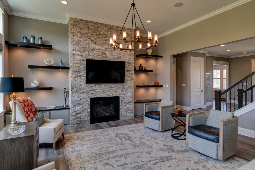 This is an example of a large eclectic open concept living room in Indianapolis with beige walls, vinyl floors, a standard fireplace, a stone fireplace surround, a wall-mounted tv and brown floor.