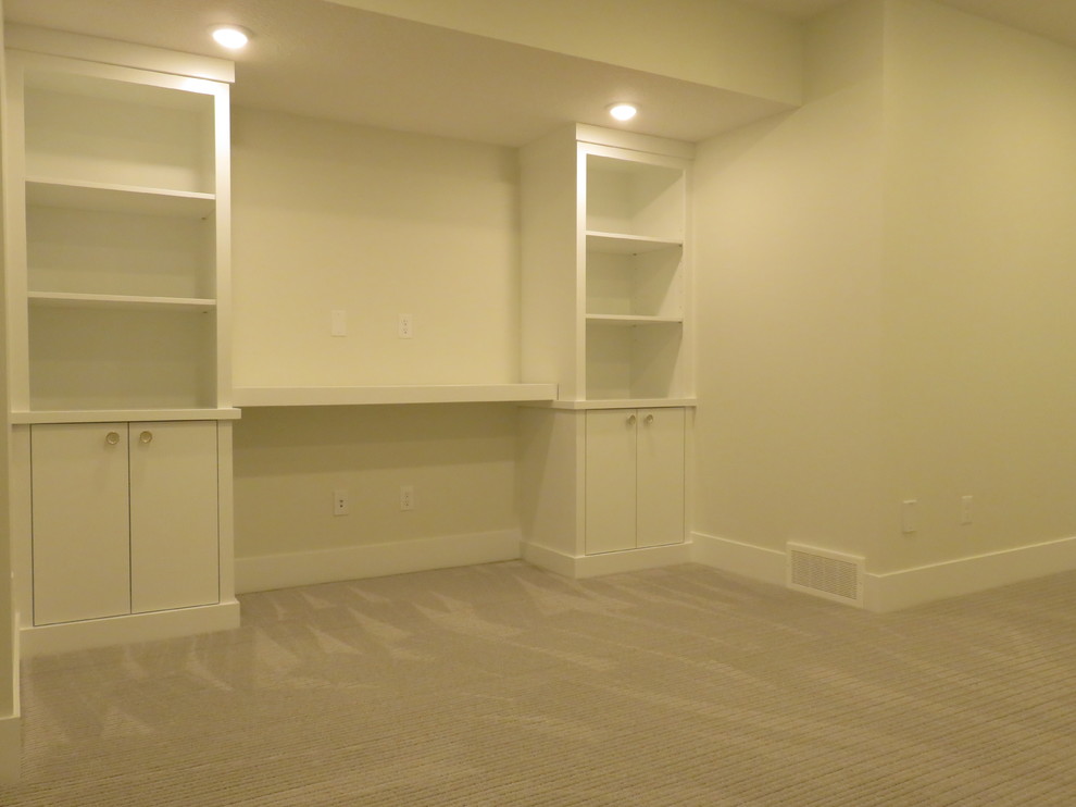 Inspiration for a mid-sized transitional look-out carpeted and gray floor basement remodel in Calgary with white walls