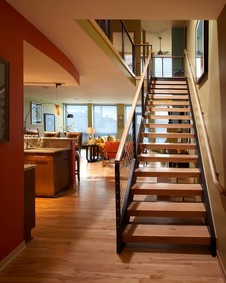 Photo of a modern wood staircase in Milwaukee with open risers.