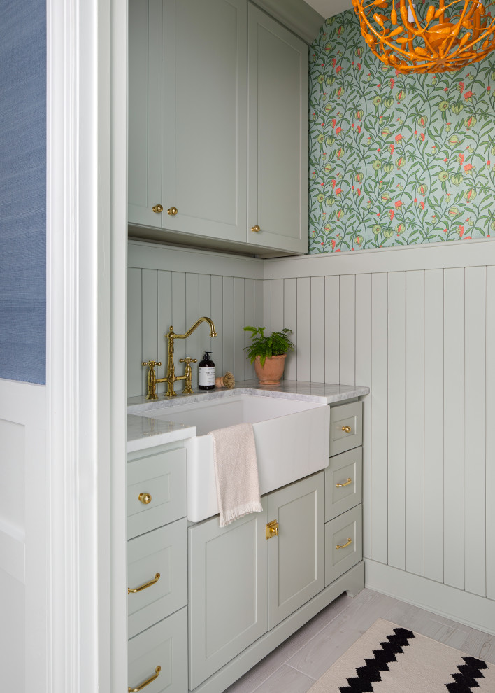 Beach style laundry room in Other with a farmhouse sink and wallpaper.