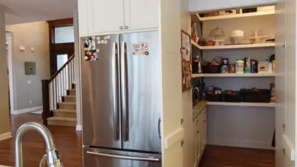 Inspiration for a mid-sized transitional l-shaped medium tone wood floor and brown floor kitchen pantry remodel with a double-bowl sink, shaker cabinets, white cabinets, quartzite countertops, white backsplash, subway tile backsplash, stainless steel appliances and an island