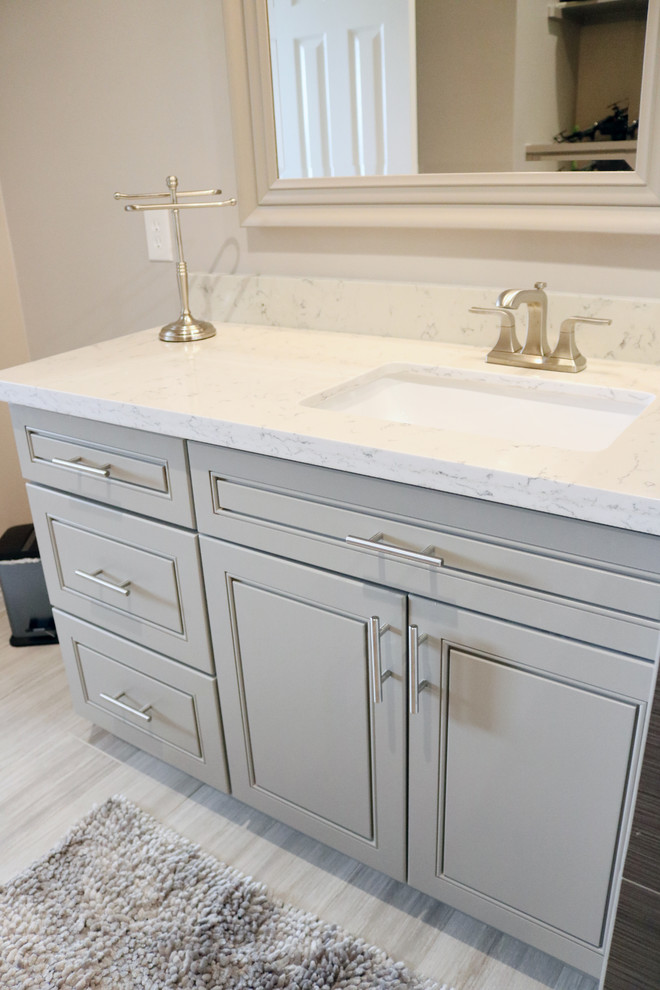 Design ideas for a small contemporary 3/4 bathroom in Houston with raised-panel cabinets, grey cabinets, grey walls, porcelain floors, an undermount sink, quartzite benchtops, beige floor and white benchtops.