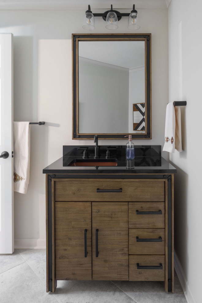 Large beach style powder room in Columbus with flat-panel cabinets, medium wood cabinets, travertine floors, an undermount sink, granite benchtops, beige floor, black benchtops and a freestanding vanity.