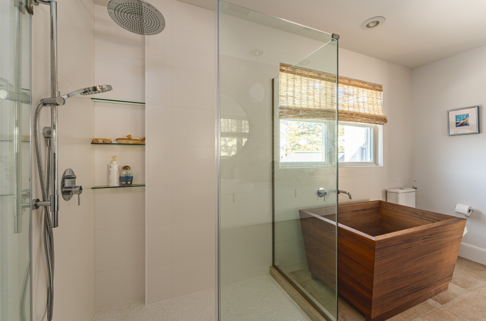 Photo of a medium sized classic ensuite bathroom in DC Metro with flat-panel cabinets, white cabinets, a freestanding bath, a corner shower, wood-effect tiles, porcelain flooring, a built-in sink, solid surface worktops, brown floors, a hinged door, white worktops, double sinks and a floating vanity unit.