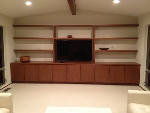 Photo of a mid-sized modern open concept home theatre in San Francisco with white walls and a built-in media wall.