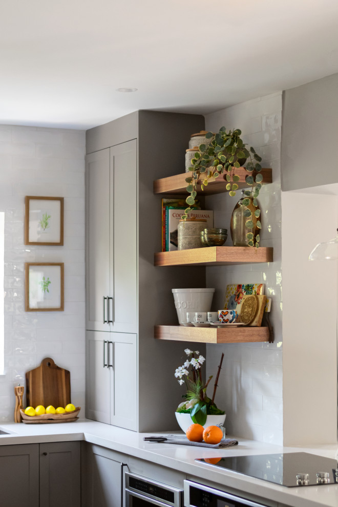 Mid-sized transitional galley medium tone wood floor eat-in kitchen photo in Miami with an undermount sink, shaker cabinets, gray cabinets, quartz countertops, white backsplash, subway tile backsplash, stainless steel appliances, a peninsula and white countertops