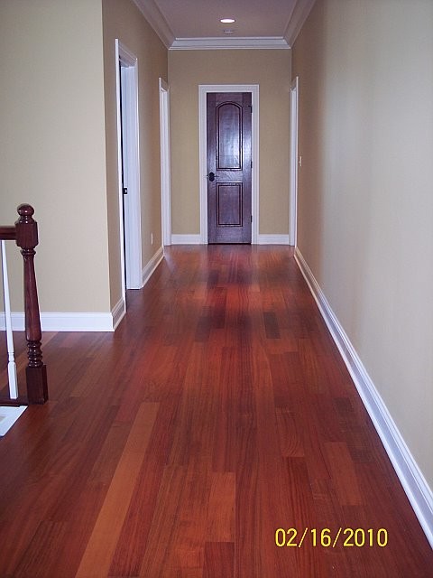 Photo of a mid-sized traditional hallway in Milwaukee with beige walls and dark hardwood floors.