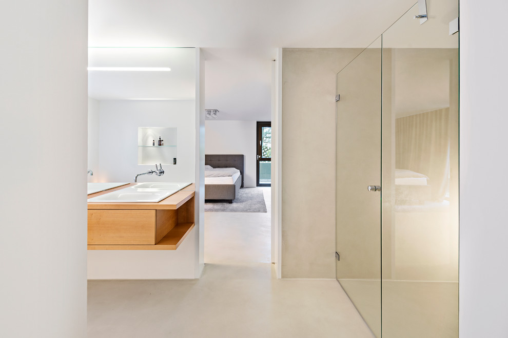This is an example of a large contemporary master bathroom in Stuttgart with beige walls, medium wood cabinets, an alcove shower, a drop-in sink, wood benchtops, flat-panel cabinets and brown benchtops.