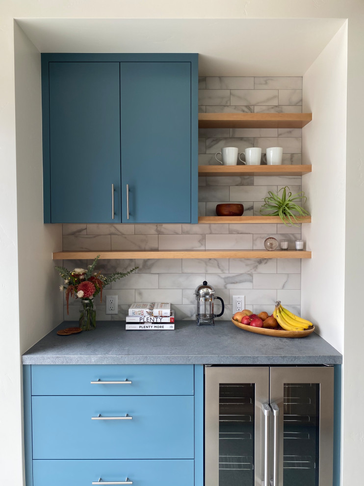 This is an example of a modern home bar in Other with flat-panel cabinets, blue cabinets, white splashback, marble splashback and grey benchtop.