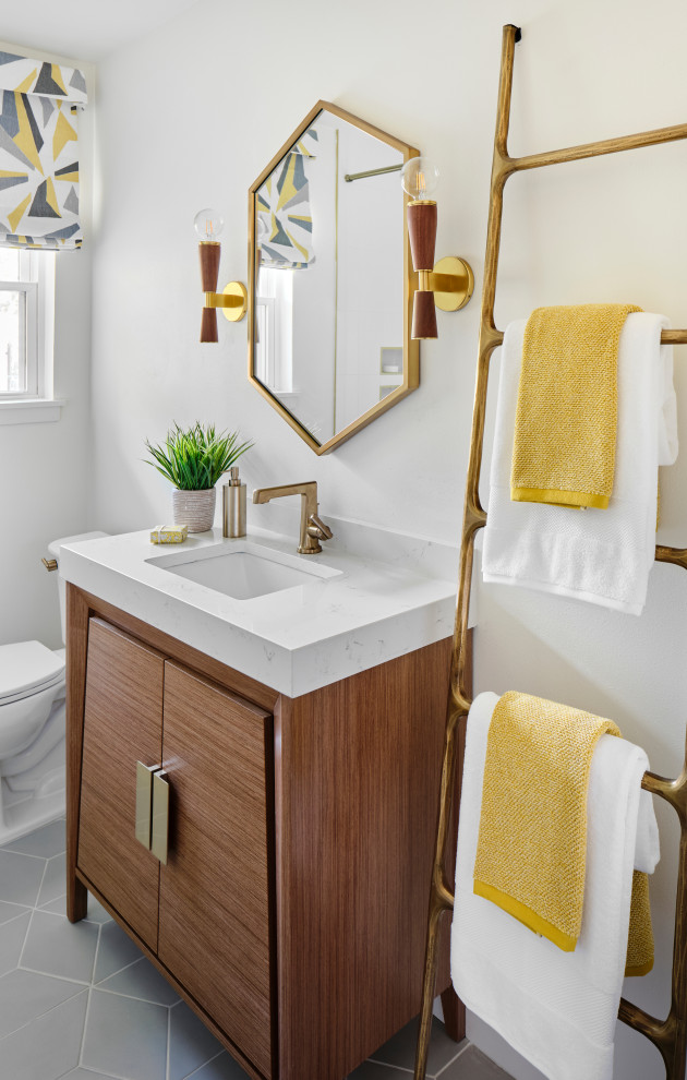 Small midcentury bathroom in Austin with medium wood cabinets, an alcove tub, a shower/bathtub combo, a two-piece toilet, white tile, ceramic tile, white walls, ceramic floors, an undermount sink, engineered quartz benchtops, grey floor, a shower curtain, white benchtops, a niche, a single vanity, a freestanding vanity and flat-panel cabinets.